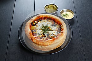 The seasoned chicago pizzza with meat, pineapple, corn, olives,