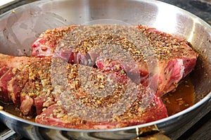 Seasoned ribeye in a pan