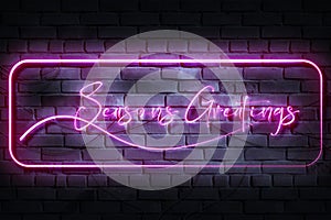 Seasons Greatings Neon Sign on a dark wall