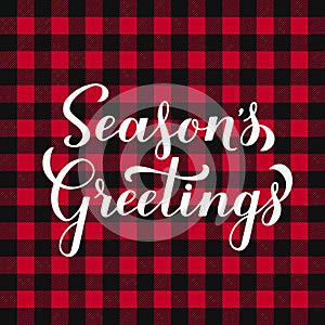 Seasons Greetings calligraphy hand lettering on red buffalo plaid background. Christmas and New Year typography poster