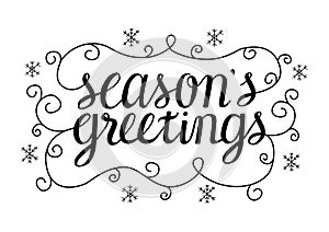 Seasons greetings calligraphy lettering with ornate elements and snowflakes