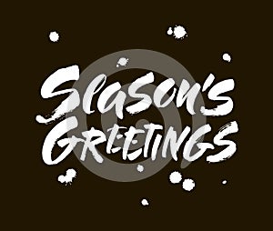 Seasons greetings calligraphy lettering text on black background with vintage paper texture. Retro greeting card for Christmas and