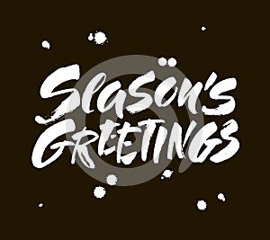 Seasons greetings calligraphy lettering text on black background with vintage paper texture. Retro greeting card for Christmas and