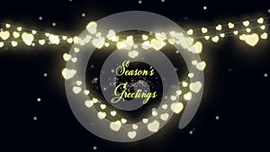 Seasons Greetings text and fairy lights forming a heart shape on black background