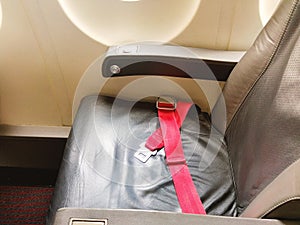 Seat belt on seat shot in airplane