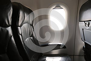 Seat inside of the plane and window space. The air line support traveler for journey to someplace.