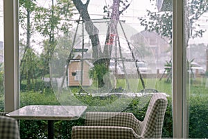 A seat with raining background and green grass