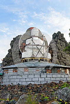 Seated Buddha in Shad Tchup Ling Buddhist monastery on mountain Kachkanar. Russia