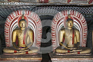 Seated Buddha statues in Cave 2 (Maharaja Viharaya) at the Dambulla Cave Temples in Sri Lanka.