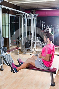 Seated cable row man rows at gym pulley machine