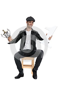 Seated casual man presenting his number one and cup cocky photo