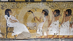 Seated Inerkhau being approached by a sem-priest and men in TT359, the Tomb of Inherkhau in Deir el-Medina.