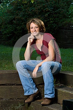 Seated Smiling Young Woman Outdoors
