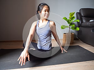 Seated spinal twist pose yoga asian woman home workout fitness body weight exercise pilates health training sport healthy