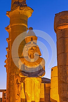 Seated Statue Of Ramses II. by The Luxor Temple Egypt. Night shot