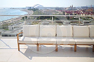 Seating area with beige sofa on the rooftop