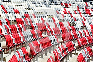 sport stadium seats in perspectivel view. curving rows of colorful plastic seats on steel frame.