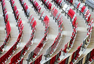 seating area detail of sport Stadium. curving rows of colorful plastic seats on steel frame.