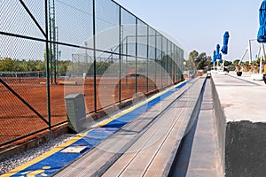 Seating area for spectators made with composite deck next to the tennis court
