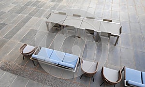 Seating arrangements with chairs and tables in a open tiled area