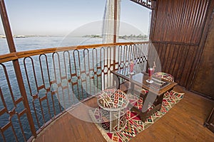 Seating on the balcony of a luxury river cruise boat with cocktails