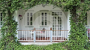 Seating on the balcony recreation place, Balcony surrounded by tropical style garden, Wooden terrace and green garden