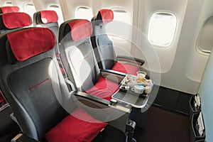 Seats on board of airplane. Cabin of economy class with screens