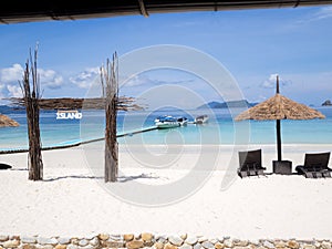 Seats with sun shelter on white sand beach sea view background, Travel plans after retirement of business people