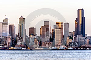 Seattle seafront with high-rise buildings downtown and ferries moored at the pier