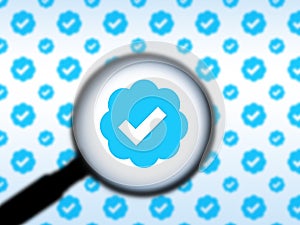 Seattle, WA USA - circa November 2022: Out of focus image of a magnifying glass zooming in on the Twitter Verification logo