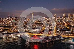 Night aerial view of illuminated Seattle Downtown and the Waterfront pier area with famous Space Needle