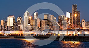 The Seattle Washington waterfront glows at dusk over Elliott Bay