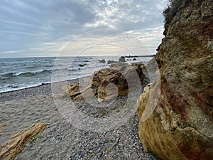 Seaview on gloomy day from rocky beach