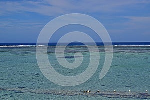 Seaview with horizon that separates water and sky with the shallow water having greater visibility