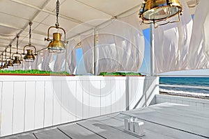 Seaview Restaurant Interior. White Terrace With Wooden Furniture