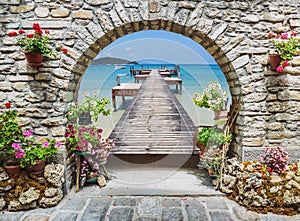 Seaview through the stone arch with flowers