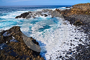 Seawater washes an empty beach on the edge of the island