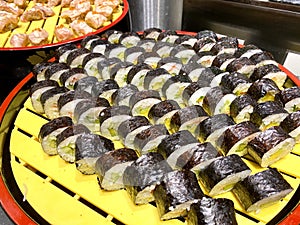 Seaweed rice rolls arranged in rows on a tray. Gimbap pattern