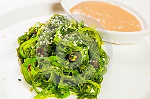 Seaweed salad with the dressing on the plate