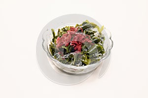Seaweed salad in a glass bowl isolated on a white background