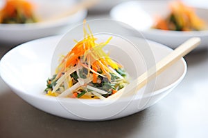 seaweed salad with julienned carrots and daikon, soy dressing