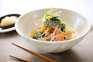 seaweed salad with julienned carrots and daikon, soy dressing