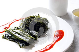 Seaweed and Seaweed fusiforme blanched in boiling water and red chili-pepper paste with vinegar. photo