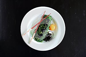 Seaweed spaghetti noodles with egg yolk, nori and caviar