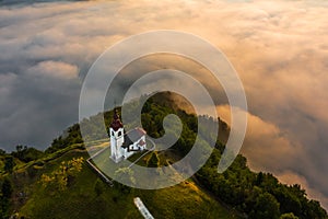 Sebrelje, Slovenia - Aerial drone view of the beautiful hilltop church of St.Ivan Sv. Ivan Cerkev at sunrise photo