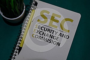 SEC - Security and Exchange Commision acronym write on a book isolated on Office Desk photo