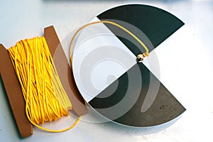 Secchi disk with rope on a white table