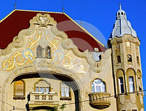 Secessionist or art nouveau style facade detail with stone balcony and white windows in Szeged, Hungary