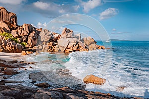 Secluded beach Grand L Anse in evening sunset light, La Digue, Seychelles. Tropical ocean coast, unique granite rocks