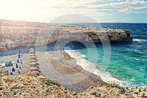 Secluded beach with no people with rocks at sunrise